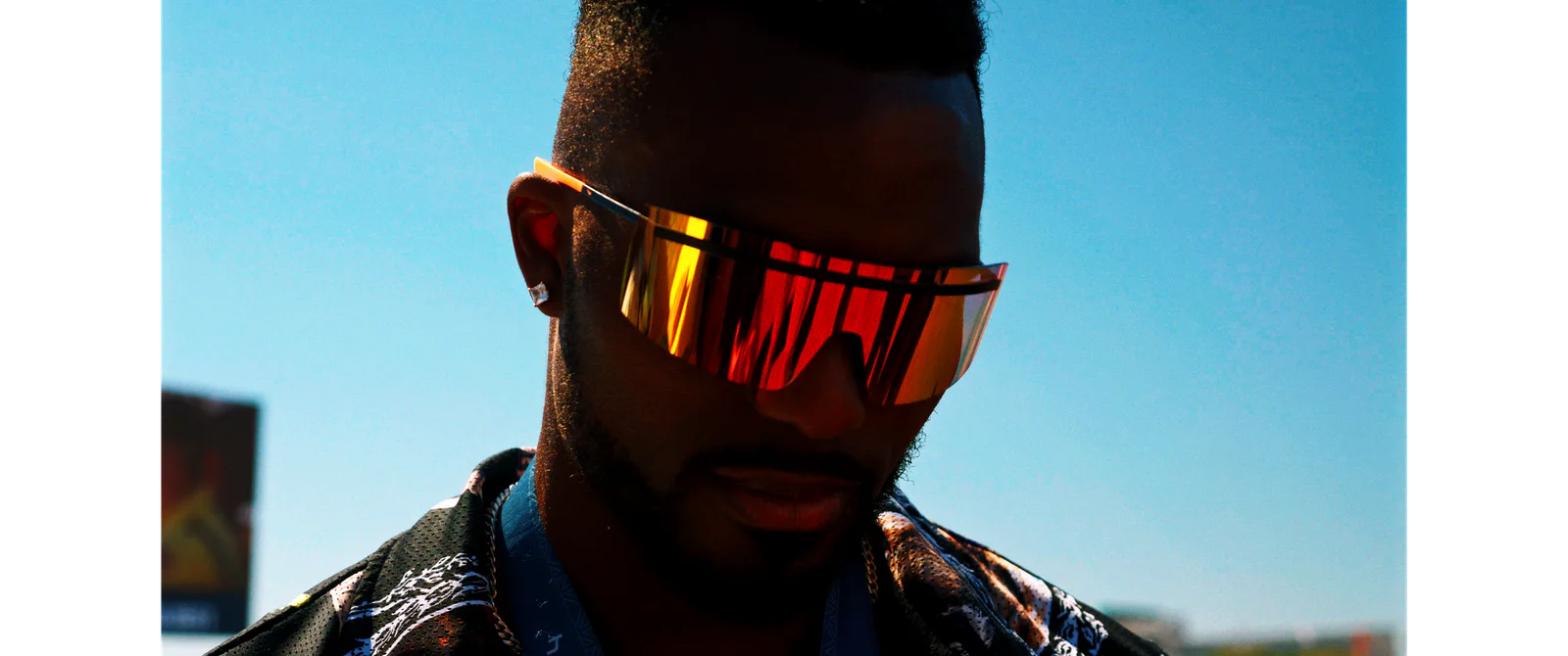 Close portrait of Kenny Bednarek wearing performance sunglasses